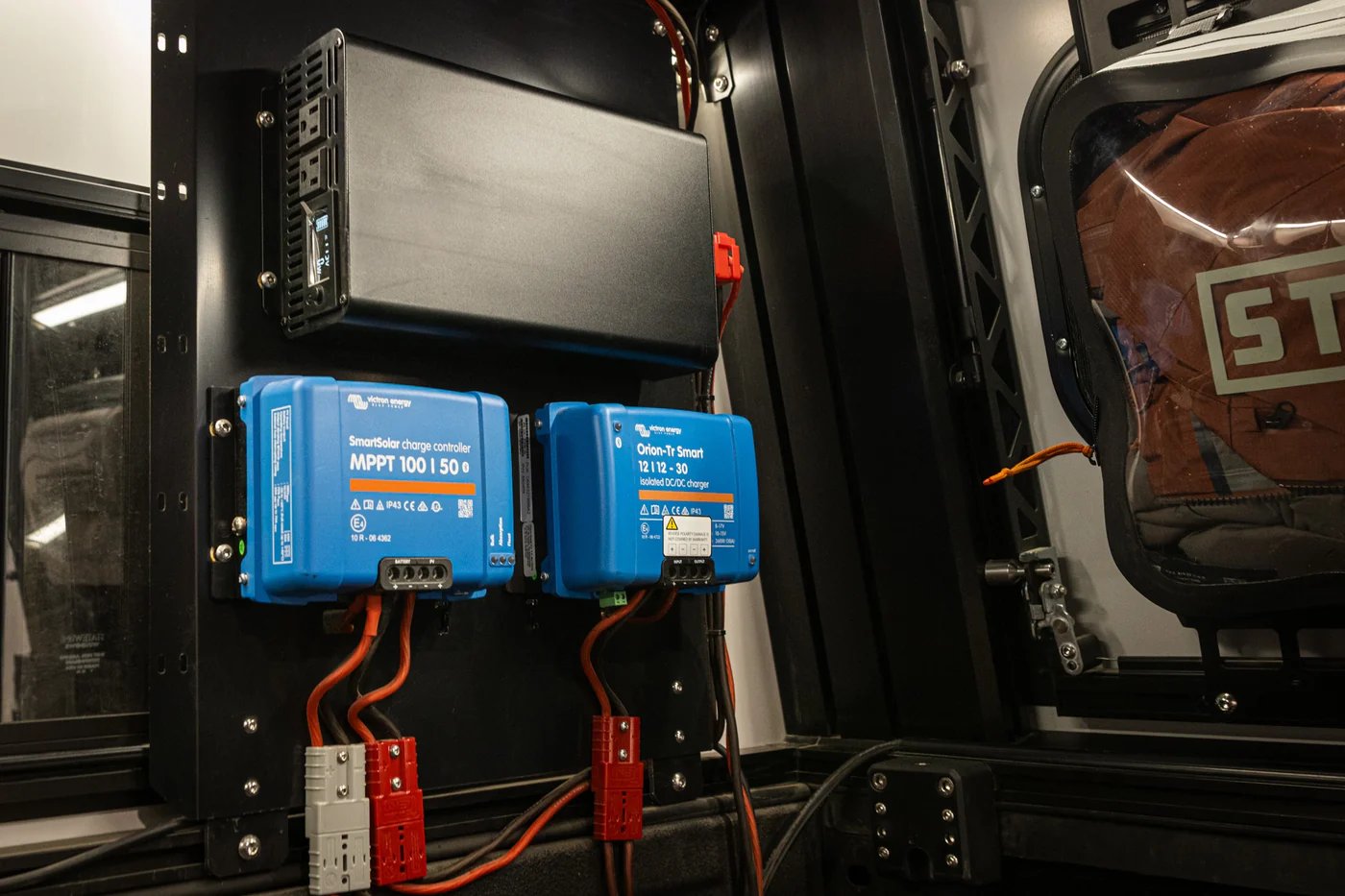 Victron SmartSolar MPPT 100/50 charge controller and Orion-Tr Smart 12/110-30 charger installed in an RV electrical system with battery connectors